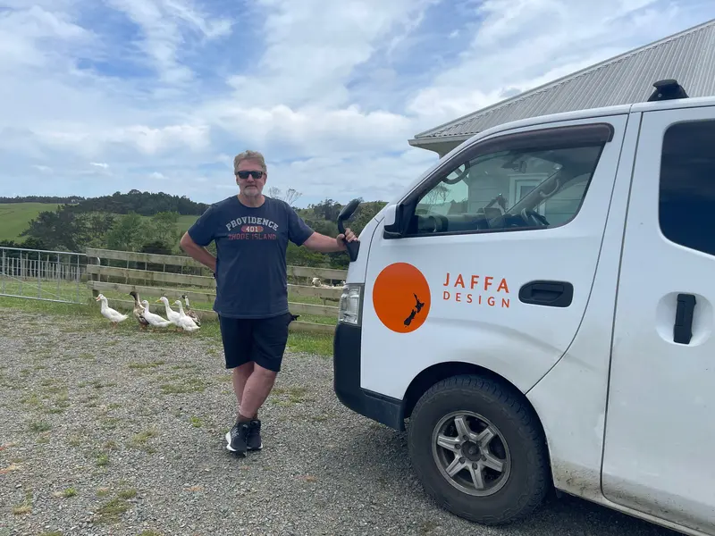 Image of Jaffa Design owner standing next to the signwrited van